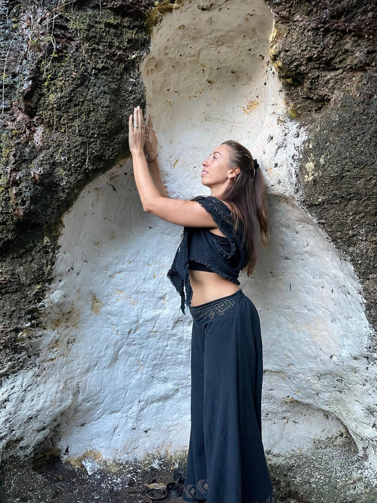 Aleesha in quiet prayer at a stone alcove